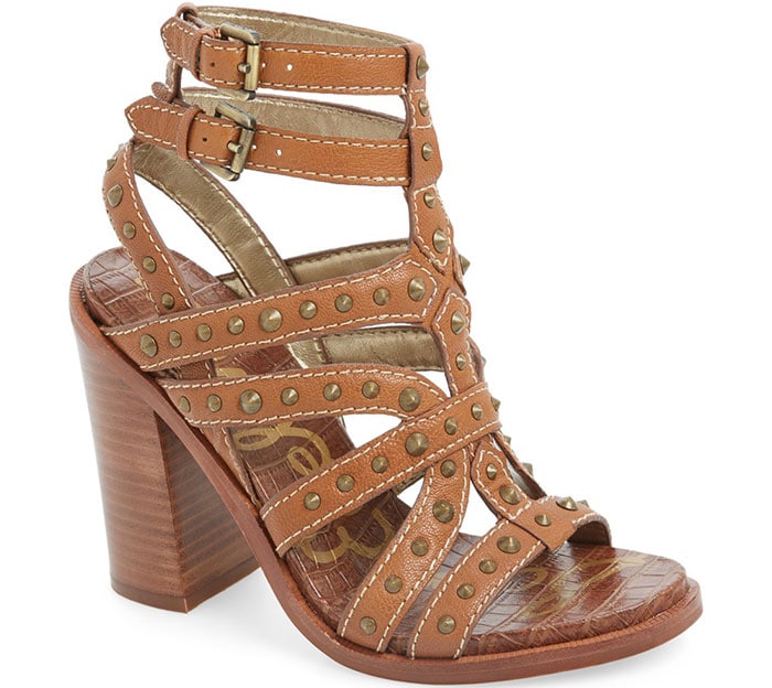 Polished cone studs play up the edgy attitude of a dramatic stacked-heel sandal topped with twin ankle straps