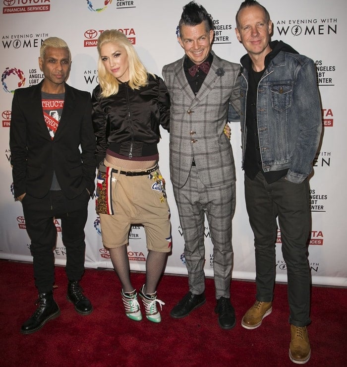 Gwen Stefani, who is approximately 5 feet 6 inches tall, is joined by her No Doubt bandmates, including Tony Kanal (approximately 5 feet 7 inches tall), Tom Dumont (about 6 feet 1 inch or 1.85 meters tall), and Adrian Young (approximately 6 feet or 1.83 meters tall)