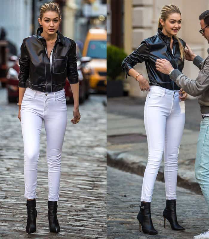 Gigi Hadid wears white jeans with a black leather jacket
