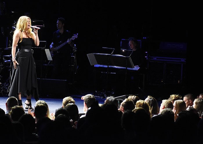 Idina Menzel commands the stage in a black strapless dress and Miu Miu wooden wedge sandals, delivering powerhouse vocals to a packed audience in Dublin, Ireland