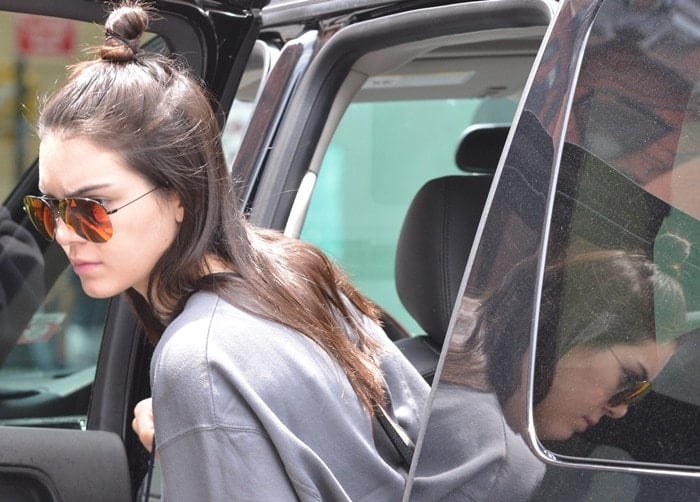 Kendall Jenner accessorized with semi-rimless Victoria Beckham sunglasses