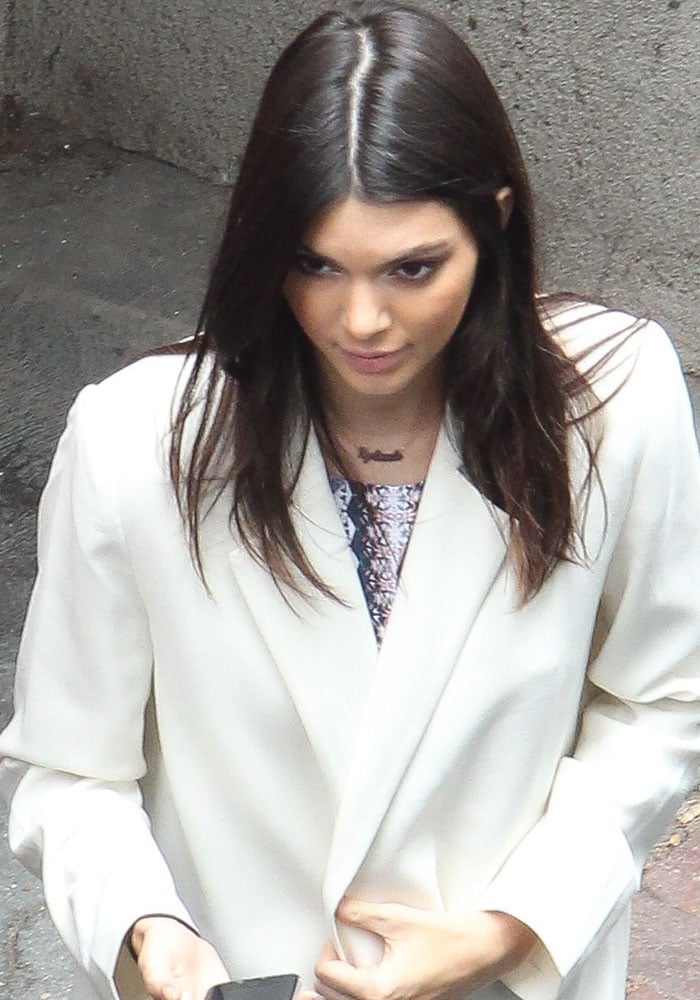 Kendall Jenner wore a romper from her own collection with a white coat