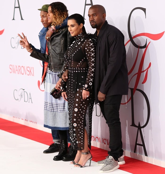 Kim Kardashian in a sheer dress with Kanye West, Pharrell Williams, and Helen Lasichanh at the 2015 CFDA Fashion Awards held at Alice Tully Hall at Lincoln Center in New York City on June 1, 2015