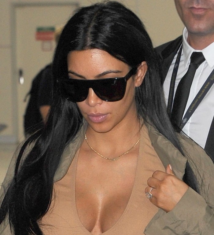 Pregnant reality star Kim Kardashian wears sunglasses and sports her giant engagement ring as she arrives at the Nice airport ahead of the Cannes Lions festival