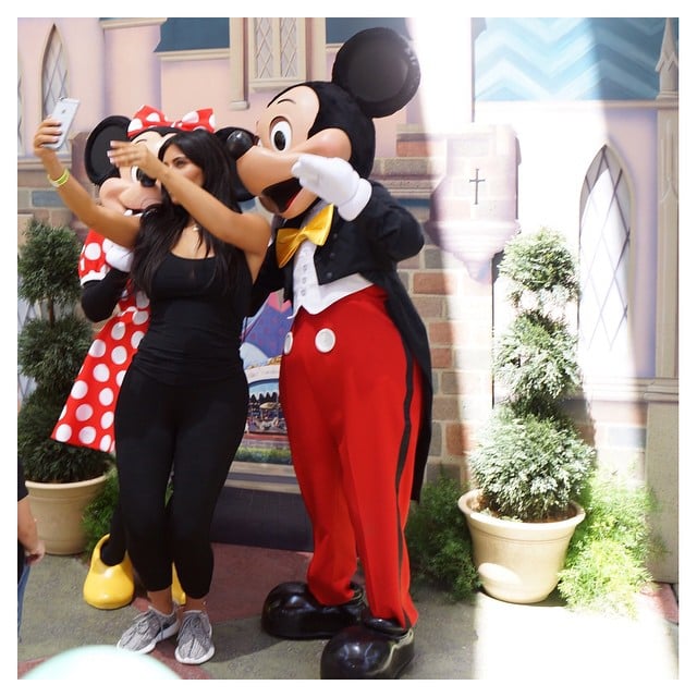 Kim Kardashian poses with Minnie and Mickey Mouse during her daughter North's second birthday at Disneyland in Anaheim, California on June 15, 2015