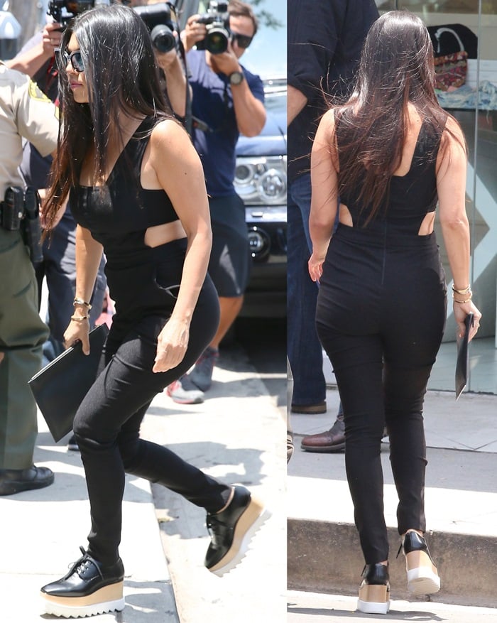 Kourtney Kardashian wore a black jumpsuit and heavy-soled Stella McCartney "Elyse" platform shoes
