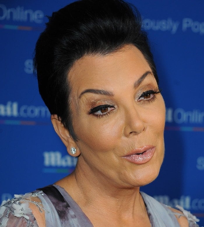 Kris Jenner's radiant look features glossy lips and a smooth complexion, highlighting her well-maintained appearance amidst numerous speculations about plastic surgery