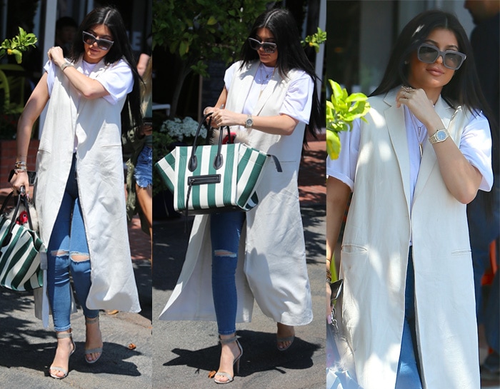 Kylie Jenner wears an American Apparel T-shirt with Topshop jeans and a white sleeveless long vest from Nomia NYC
