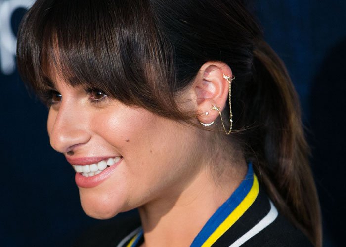Lea Michele elevates her look with delicate gold ear cuffs and a dainty chain earring