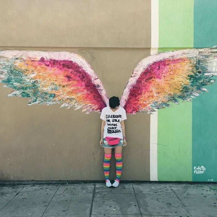 Lily Collins in front of the Angel Wings mural in Los Angeles