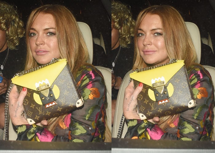 Lindsay Lohan shows off her Louis Vuitton purse