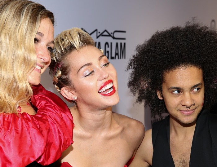 Miley Cyrus poses with friends