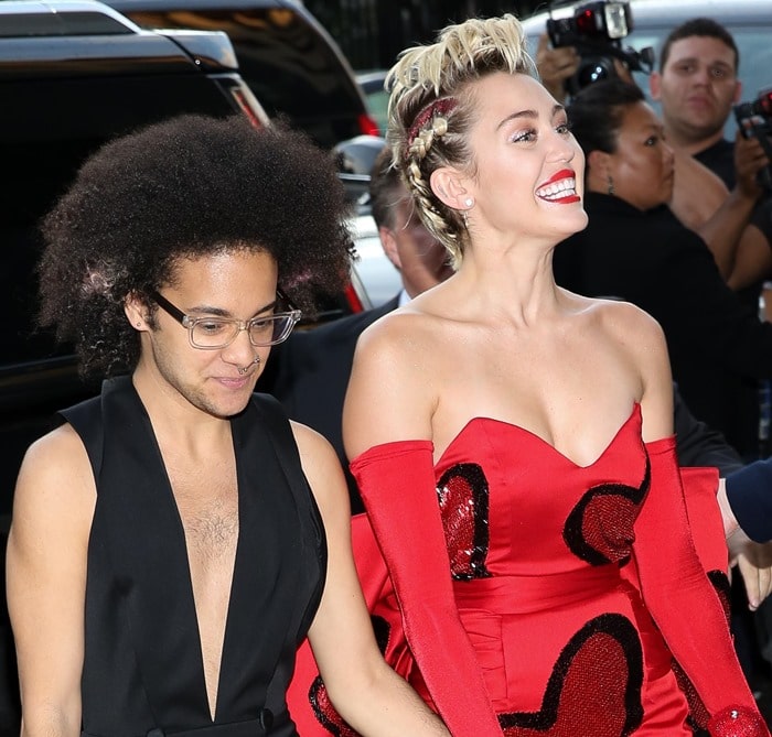 Miley Cyrus and her friend Tyler Ford arrive at the 2015 amfAR Inspiration Gala in New York City