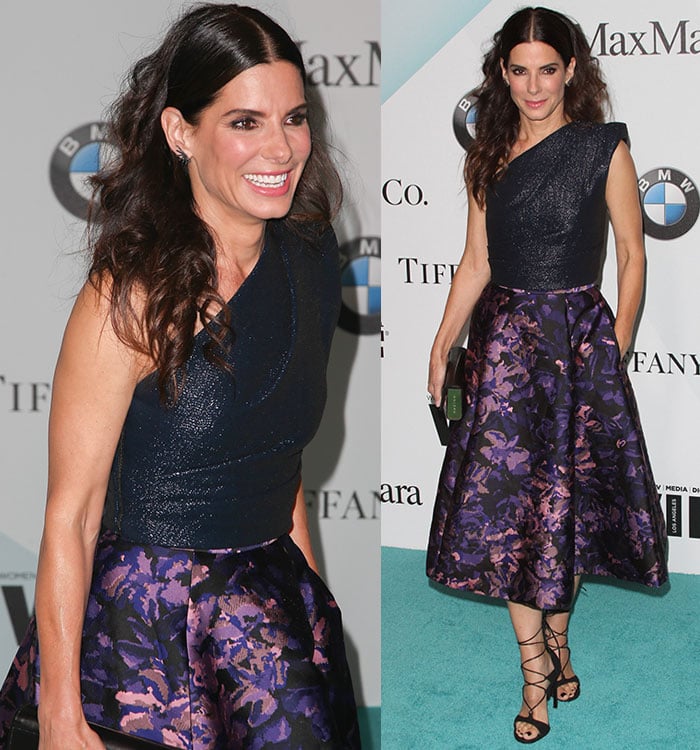 Sandra Bullock lets her brown hair fall around her shoulders in curls as she poses for photos