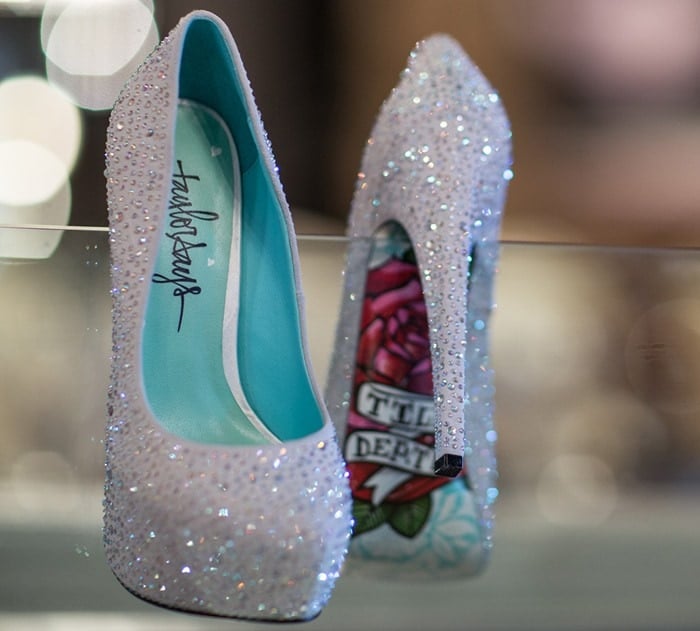 A pair of captivating pumps, available in both black and silver that stand out with their shimmering rhinestones, sky-high 6-inch heels, and a sole that blooms with flowers and the enduring pledge Till Death Do Us Part