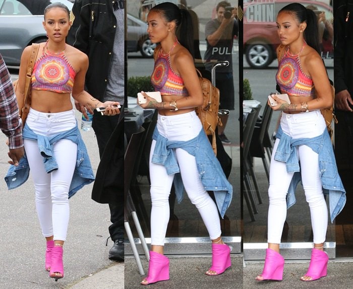 Karrueche Tran in a teeny midriff-baring halter top and white skinny jeans