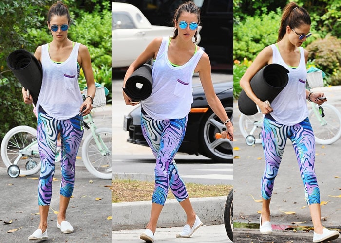 Alessandra Ambrosio struts her stuff in her post-yoga outfit, complete with a black yoga mat in hand
