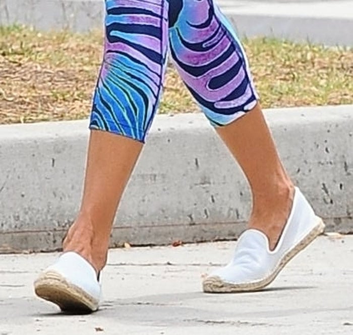 Alessandra Ambrosio shows off the white Soludos flats she finished off her post-yoga ensemble with