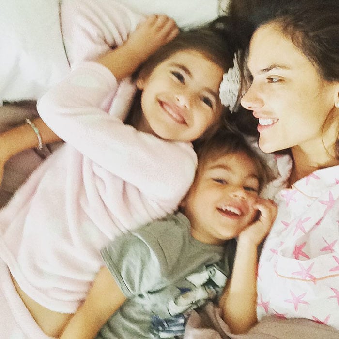 Alessandra Ambrosio shares a heartwarming moment with her children, capturing smiles and family joy in a cozy setting