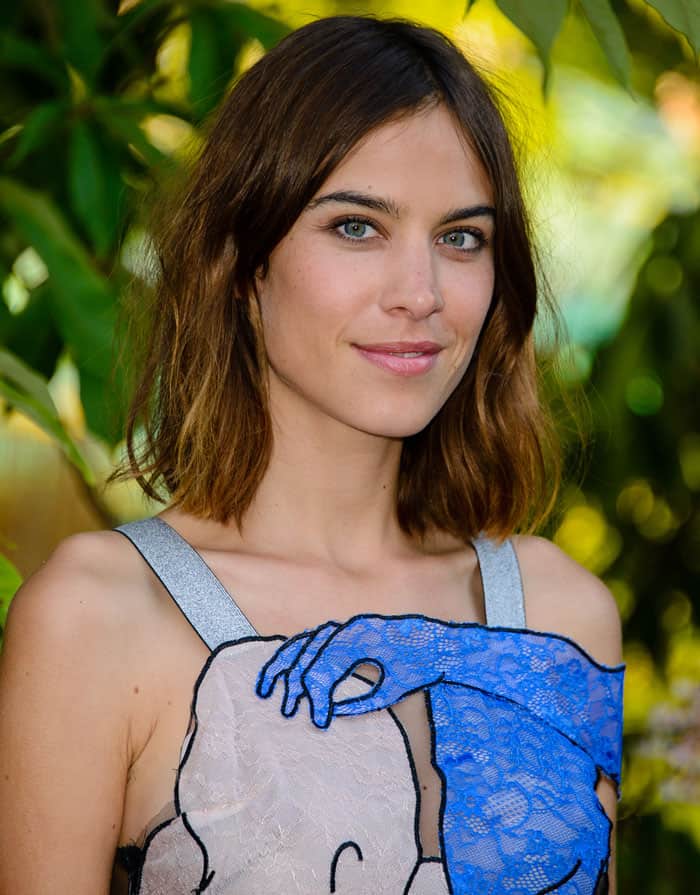 Alexa Chung in a dress featuring the image of two lovers