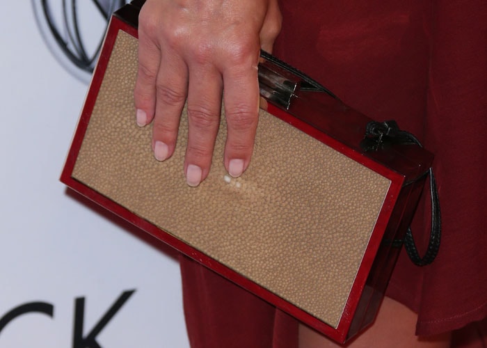 Ali Larter shows off her fresh manicure while clasping a clutch