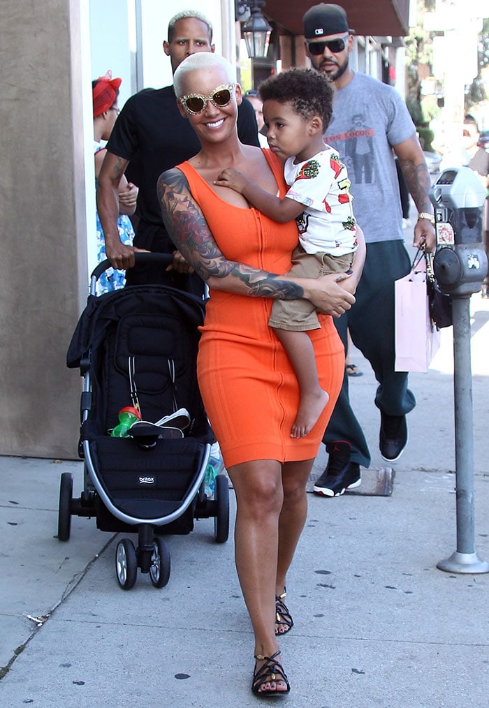 Amber Rose flaunted her curves in a form-fitting orange dress with a zip-up front by Ohne Titel