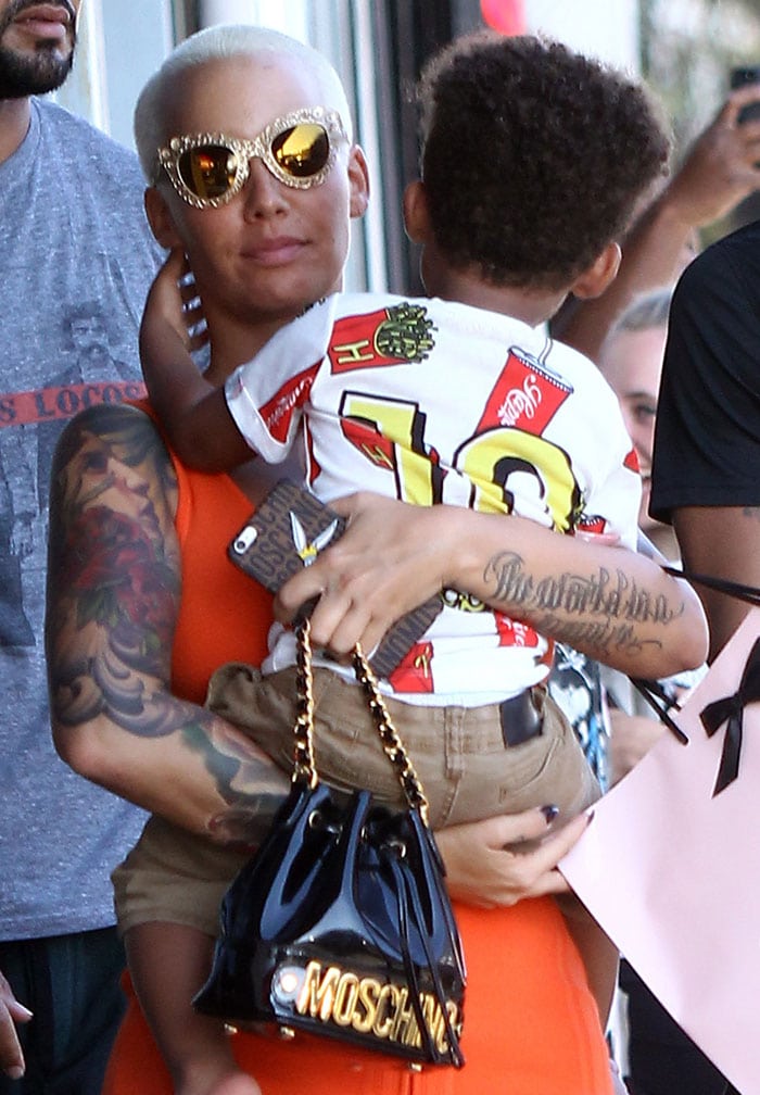 Amber Rose carrying her son, Sebastian, as she goes on a shopping spree in Los Angeles on July 29, 2015