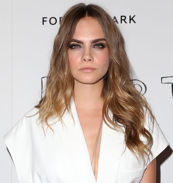 Cara Delevingne let her center-parted curled tresses fall loosely on her shoulders