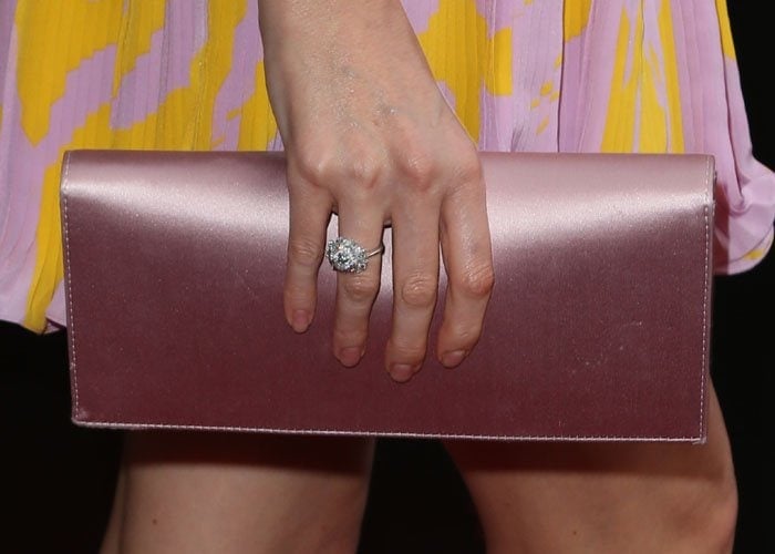 Charlize Theron showed off her glittering ring and clutch handbag