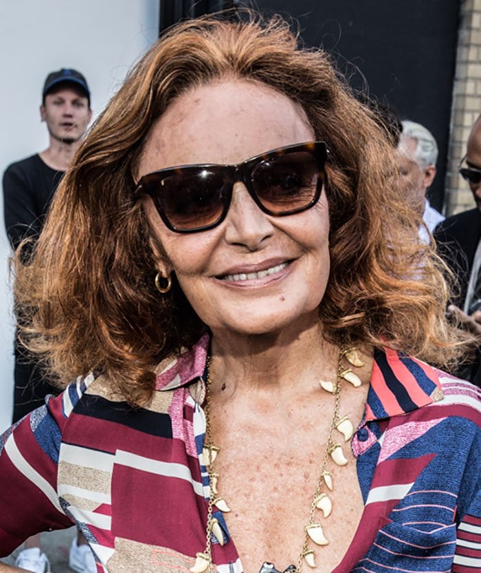 Diane von Fürstenberg accessorized her mini dress with a captivating shark-tooth necklace and elegant tortoise sunglasses