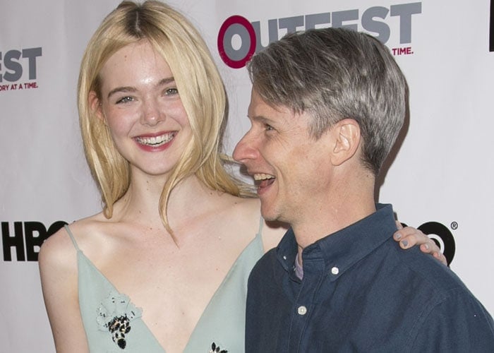 Elle Fanning (L) and John Cameron Mitchell arrive at the opening night gala of "Tig" at the 2015 Outfest Los Angeles LGBT Film Festival
