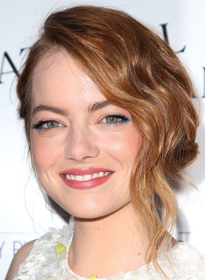 Emma Stone's wavy blonde tresses in a chic side-swept updo