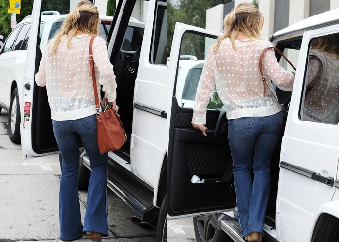 Hilary Duff with a brown bag slung over her shoulder