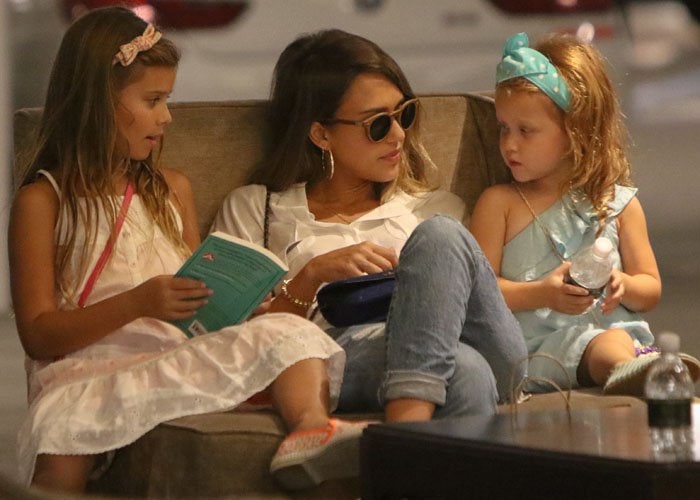 Jessica Alba cozies up on a chair with her two daughters