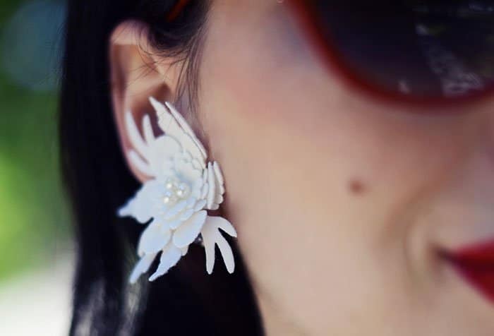 Karina's white floral earrings