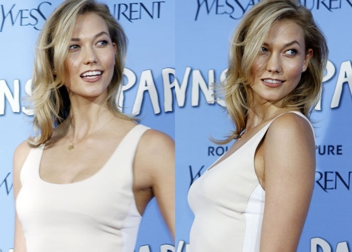 Karlie Kloss throws a sultry glance over her shoulder at the red carpet premiere of "Paper Towns"