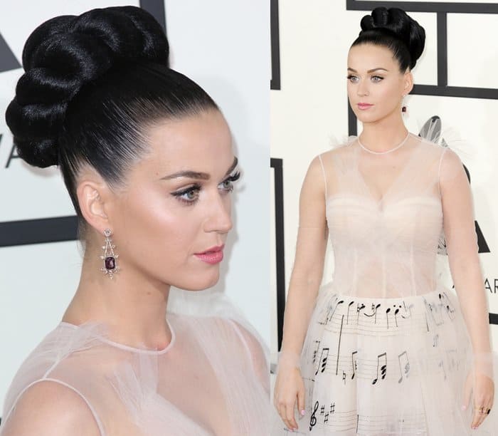 Katy Perry graces the red carpet at the Grammy Awards in a whimsical Valentino couture gown adorned with musical notes, complemented by a sleek braided updo and chandelier earrings