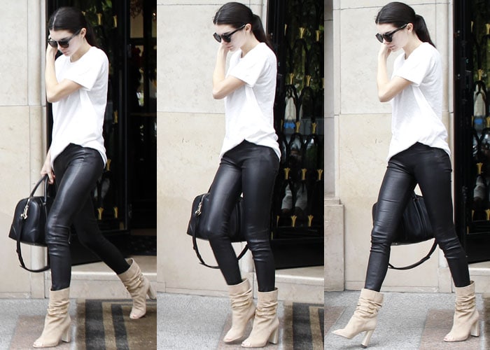 Kendall kept her look neutral in dark sunglasses, a plain white t-shirt, leather pants, taupe suede boots and a black bag