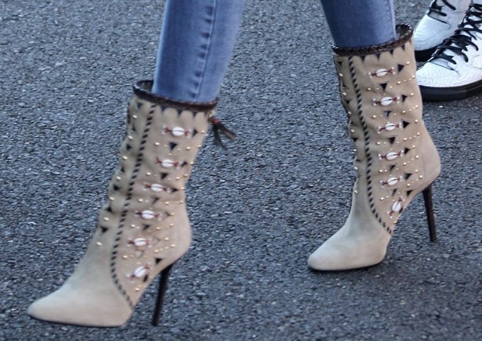 Tamara Mellon's Bohemia boots feature intricate whipstitching, tribal-inspired embellishments, and high stiletto heels that blend boho edge with modern glam