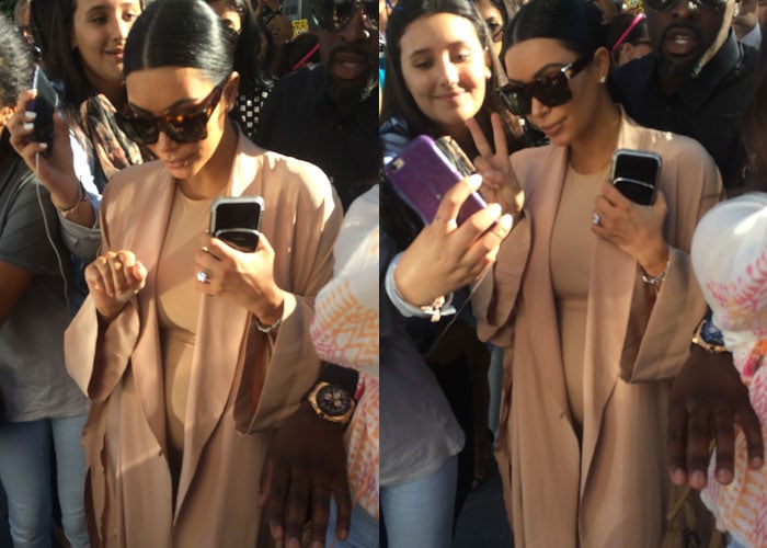 Kim Kardashian poses for selfies with fans in an all-neutral outfit