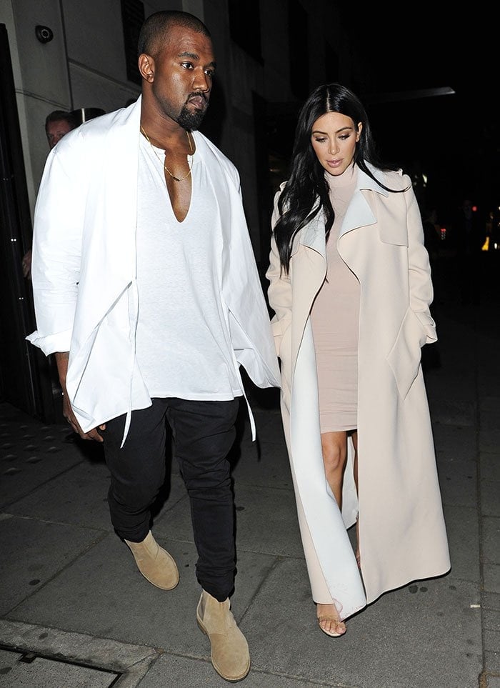 Kanye West wore a white tee, a white wrap-style kimono overshirt, black jeans, and nude Chelsea boots