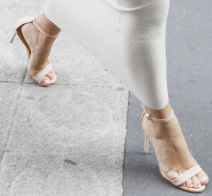 Kim Kardashian elevates her Paris look with sleek, nude elongating heels perfectly complemented by an impeccably polished pedicure