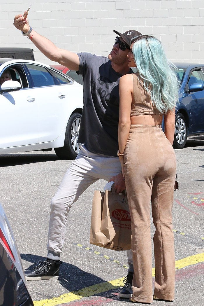 Kylie Jenner taking a selfie with a fan