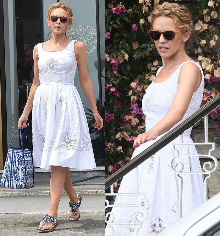 Kylie Minogue showcases her blue-and-white Dolce & Gabbana look as she boards a yacht