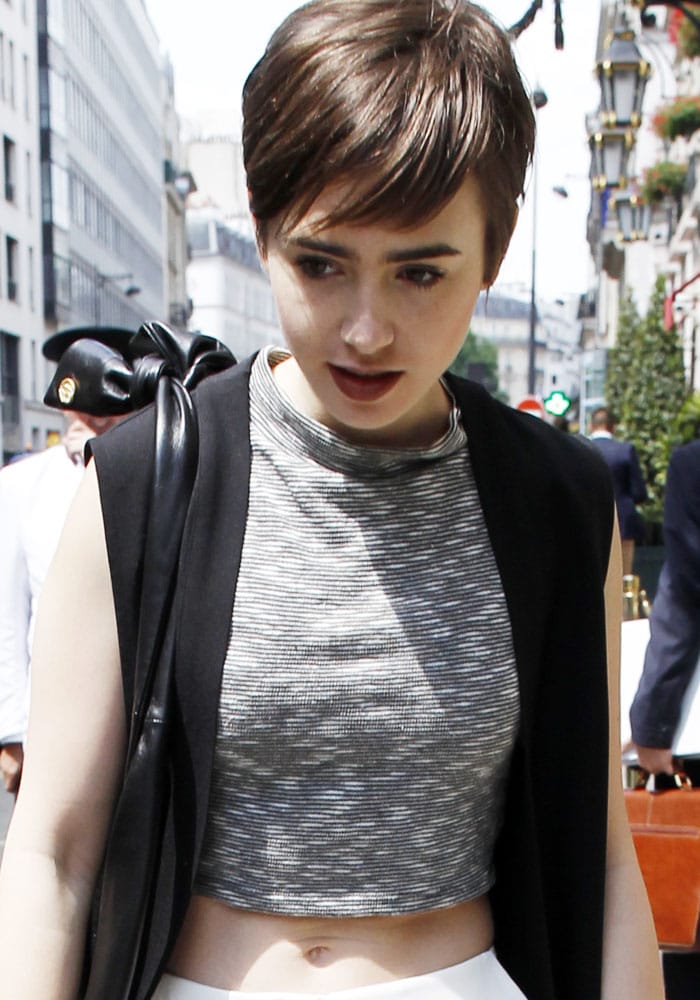 Lily Collins reveals her belly button in a crop top