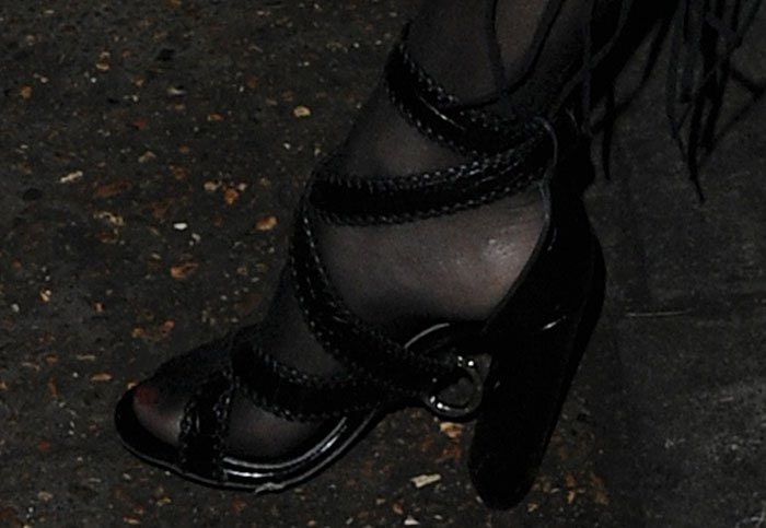 Rita Ora shows off the detail on her chunky black shoes