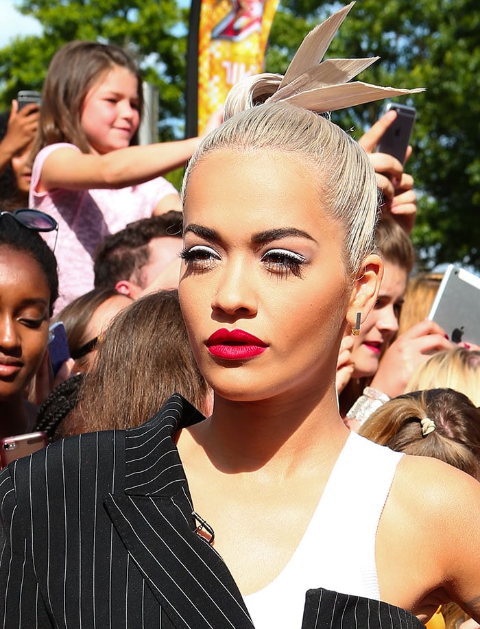 Rita Ora's makeup included white eyeshadow and her signature bright red lipstick