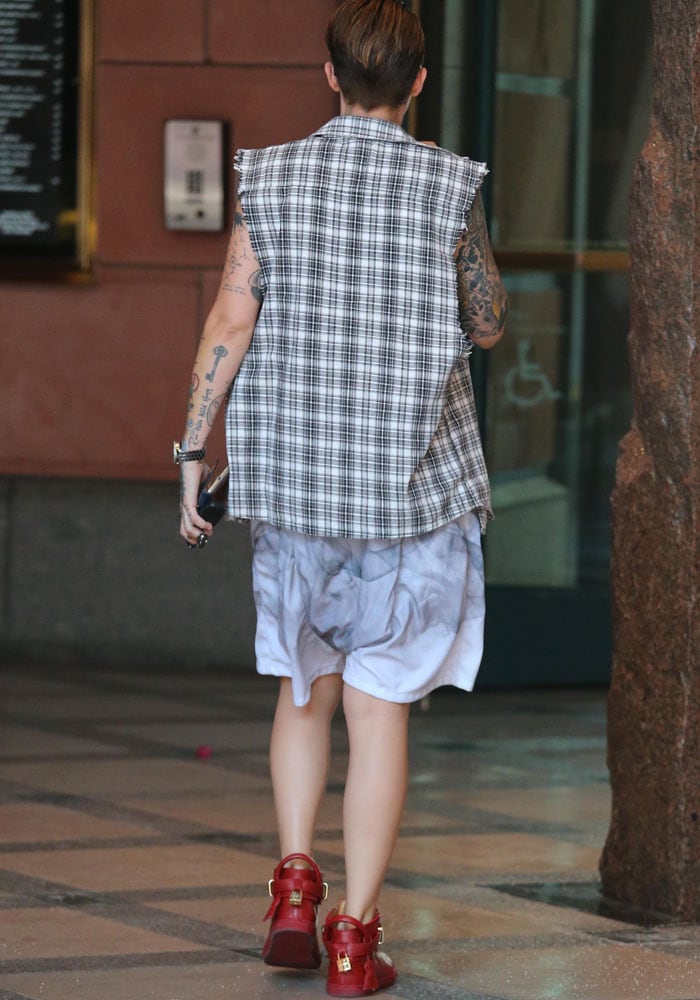 Ruby Rose wears a sleeveless flannel shirt and baggy shorts