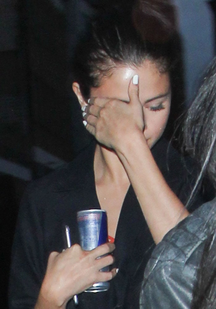 Selena Gomez arrives for dinner looking tired and holding a can of Red Bull on July 27, 2015 at Chiltern Firehouse in London, England