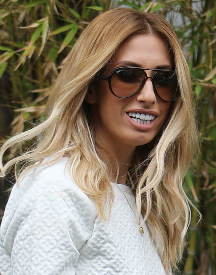 Stacey Solomon's blonde hair was styled in beach waves with a center parting